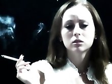 Cute brunette is having a smoke while talking to the camera