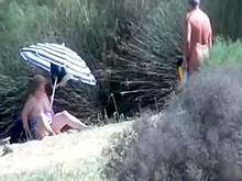 Pervert granny masturbates in front of stranger at beach